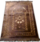 Grand tapis de luxe epais de couleur marron avec motifs discrets indiquant la direction de La Mecque
